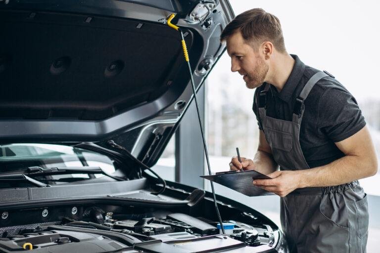 Car mechanic doing pre-purchase inspection