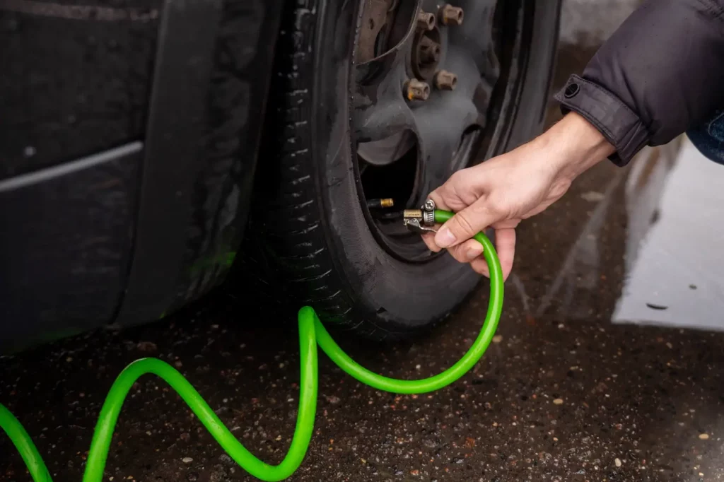 Inflating Car tyres using a  pump.